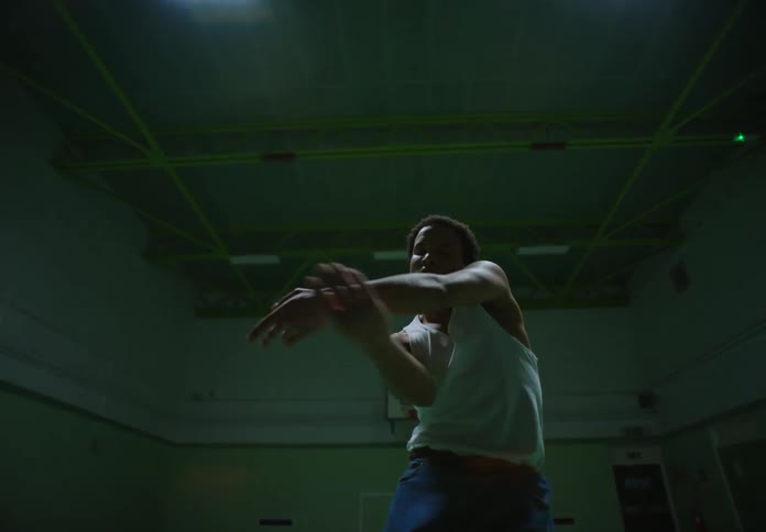Man inside an indoor space with lighting dancing