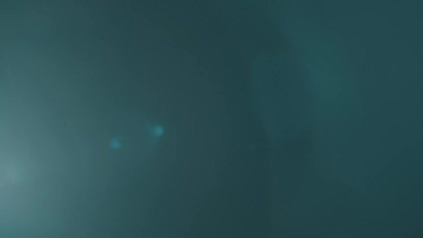 A soft dim blue light shines against a dark background