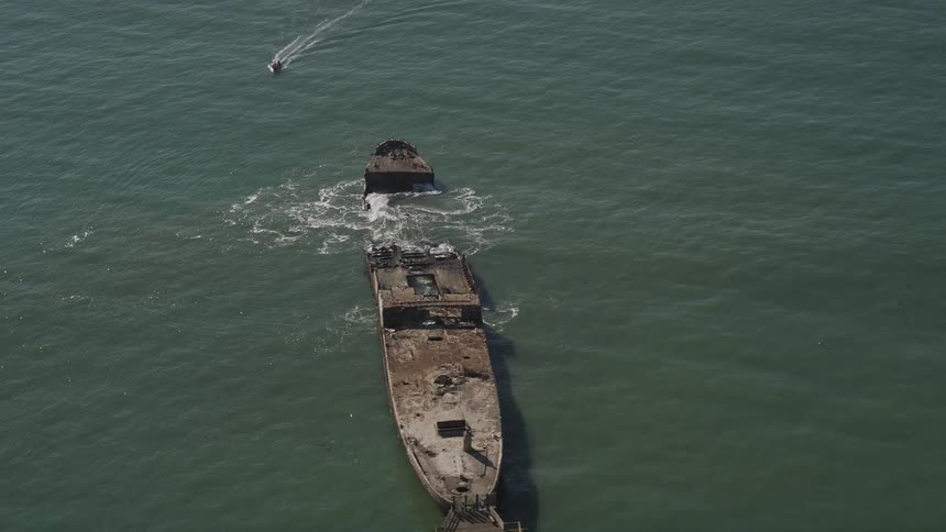 Aerial view of a partially sunk shipwreck