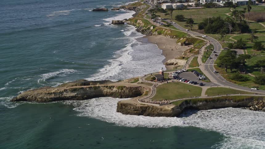 Traffic flows along coastal highway passing church on route to residential neighborhoods