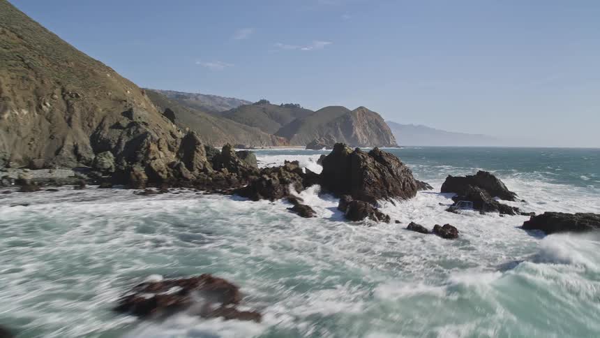 Landscape on a blue sky day with a vast sea that bathes mountains