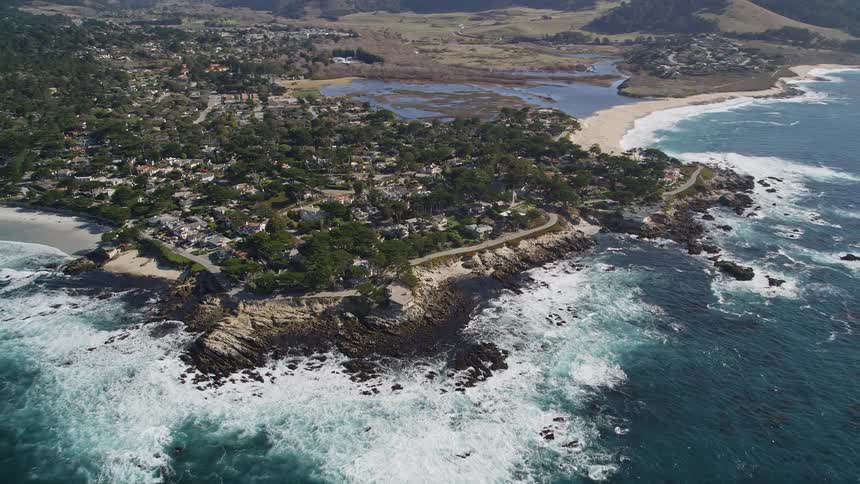 Aerial of a housing village on a rocky ocean coastline