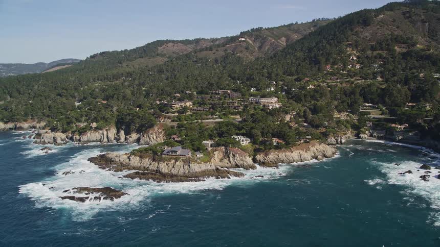 Houses built on a rocky wooded crust by the sea