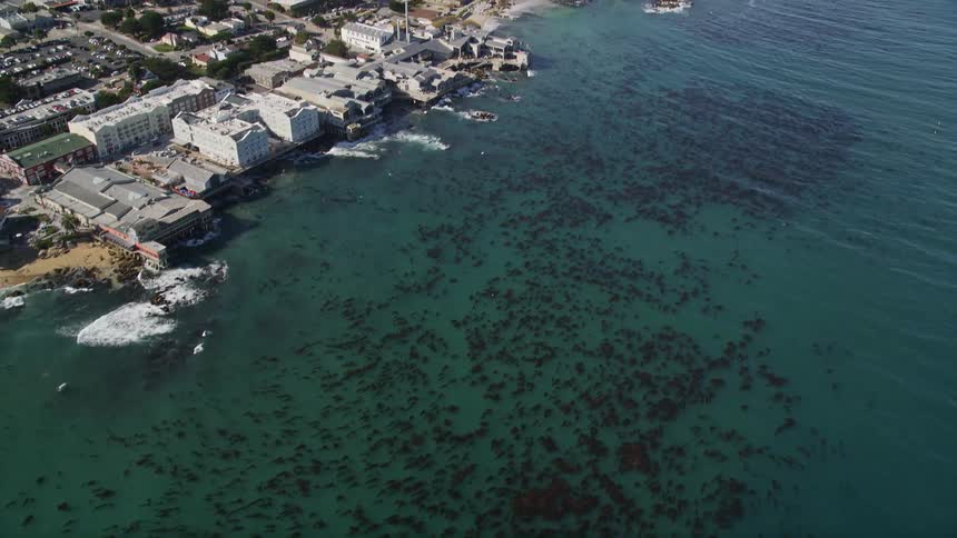 Aerial panorama of an urban city with buildings and houses on a peninsula by the sea