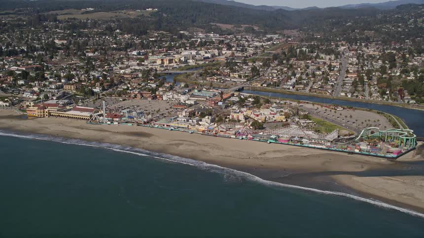 Aerial panorama of an urban city by the sea with mountains on the horizon