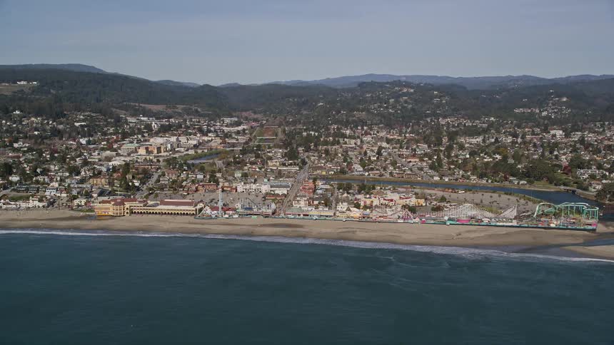 Aerial view of a coastal city with a long beach
