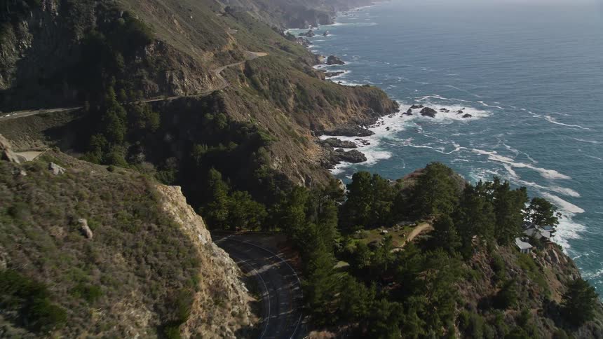 Aerial landscape of rocky coast with curvy highway and seaside