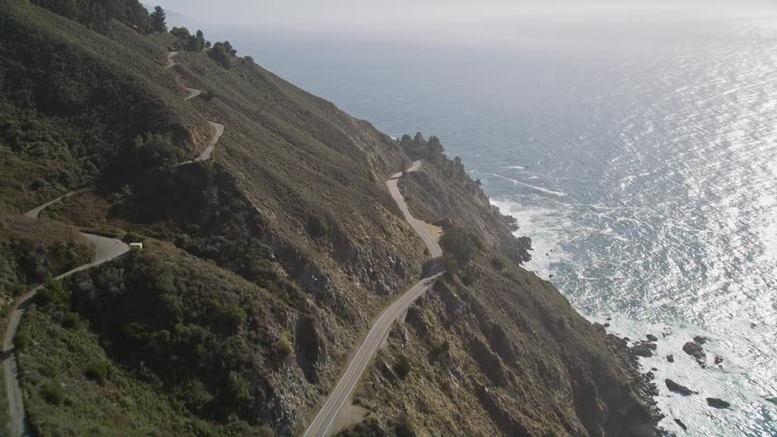 Winding road in wooded mountain by the sea