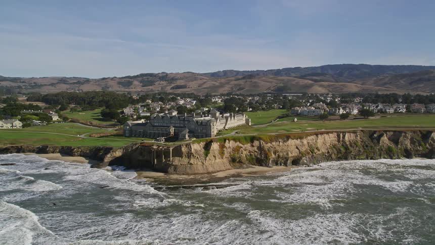 Aerial panorama of a castle and an urban city on the coast by the sea