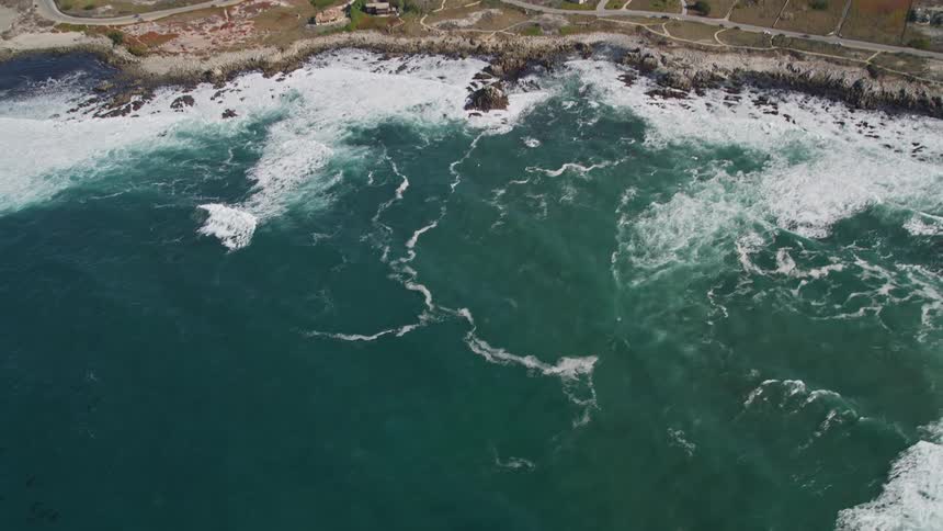 Aerial view of an urban city on a peninsula surrounded by the vast blue sea