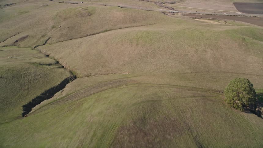 Aerial panorama of greenish mountains with winding roads