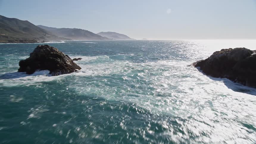 Landscape of a peninsula with vast blue sea and the edge of mountains