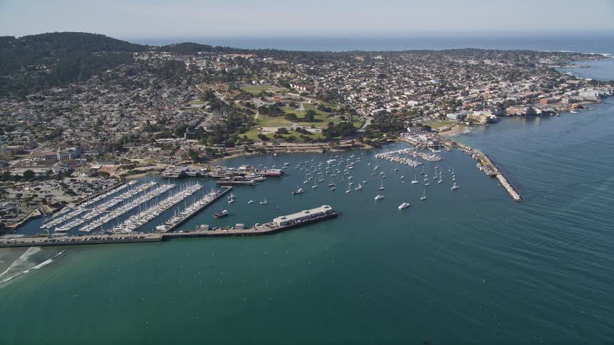 Panorama seen from above of an urban city on a seaside peninsula with docks and yachts