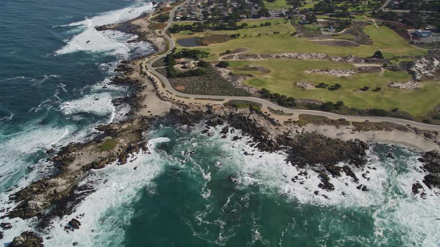 Aerial scene of an urban city on a peninsula surrounded by a vast sea