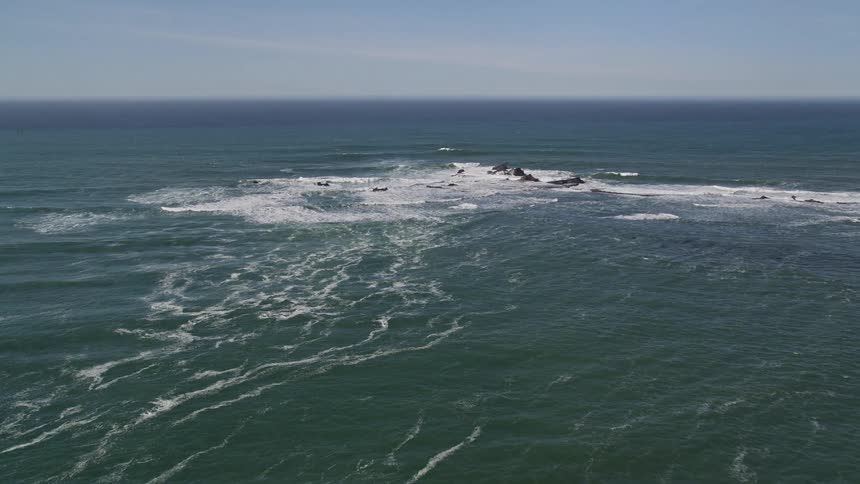 Aerial landscape of a vast blue sea against a clear sky