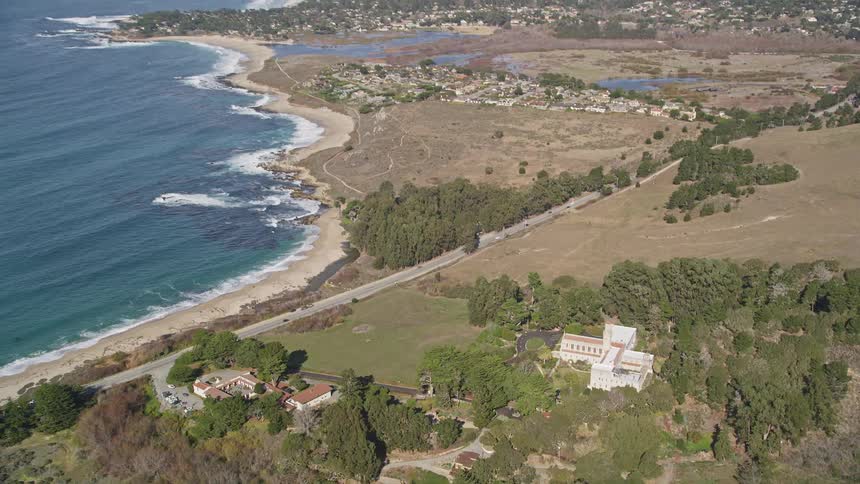 Aerial view of the carmelite monastery stands out dramatically against the turquoise water and lush green cliffs of the coastline