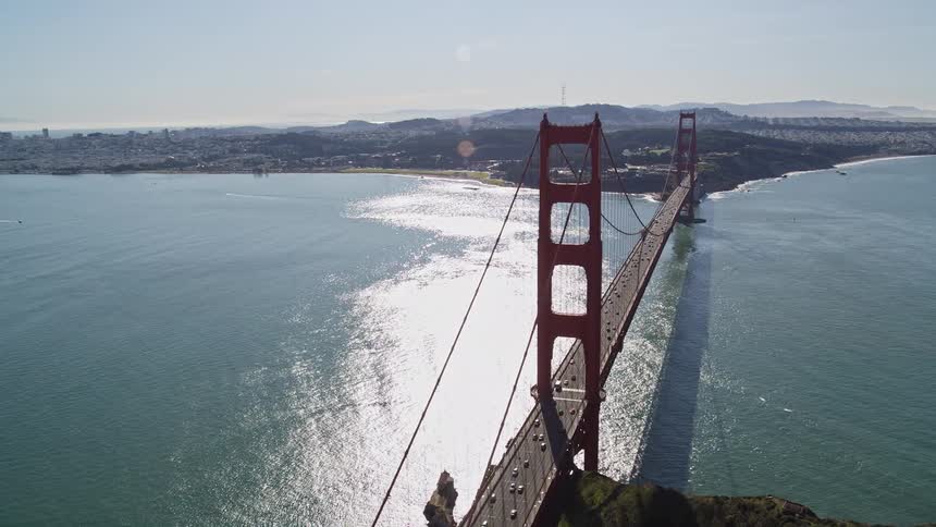 Aerial view showcases the iconic golden gate bridge stretching majestically across the vibrant blue waters of the golden gate strait