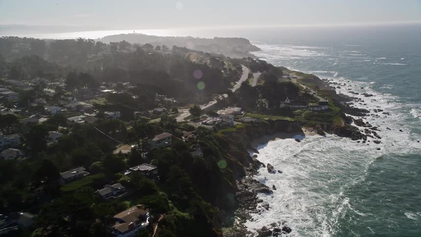 Urban city built on the rocky coast at the edge of a vast sea