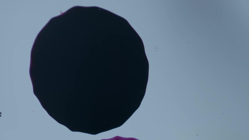 A splatter of dye hits a surface