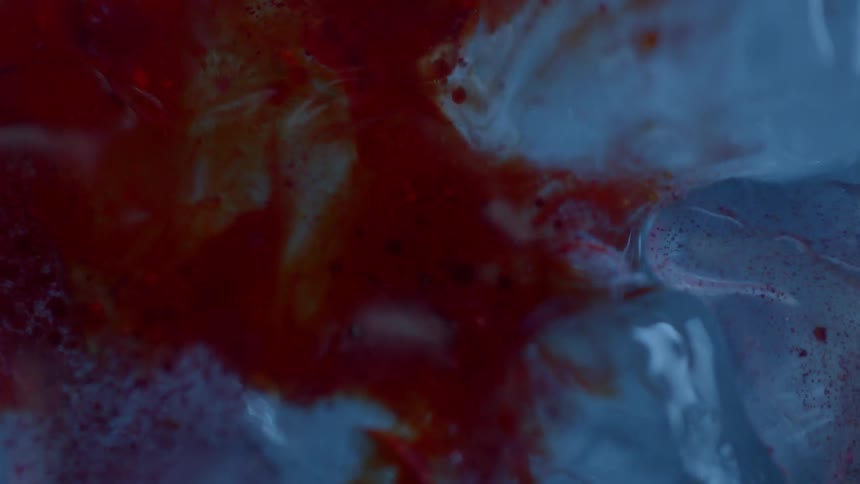 Red liquid is injected around clear ice