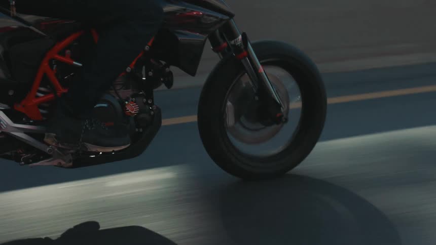 Motorcyclist rides along freeway in opposite direction of traffic jam