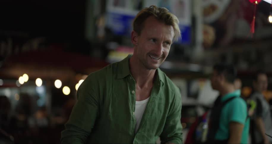 A man talks and has fun at night in the city