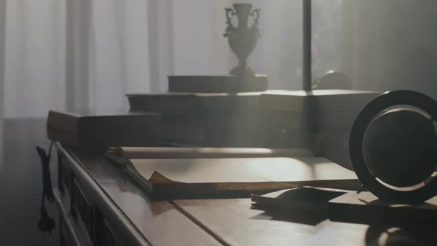 Table with books and reflection of sunlight