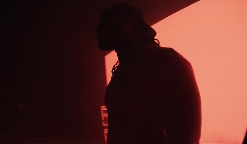 A man is posing in front of flashing lights