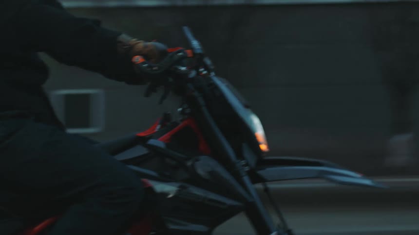 Person riding a motorcycle through the streets of a metropolis