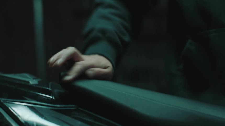 Man with his hands adjusting a seat on a motorcycle