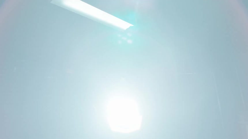 A bearded man is on top of a motorcycle with its headlights on and the left indicator flashing