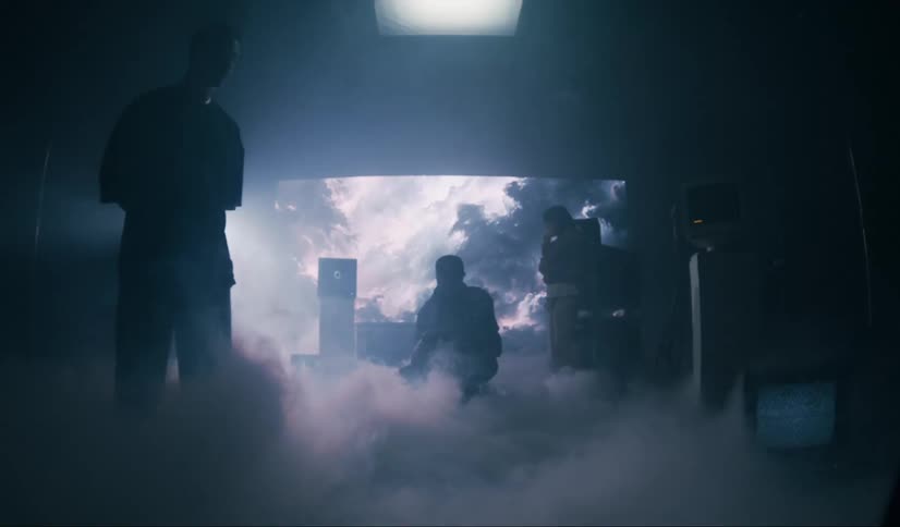 Three men inside a studio with cinematic lights and artificial smoke in a studio room