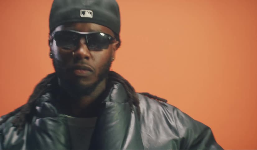 Portrait of a model man shaking his head while wearing a cap and sunglasses