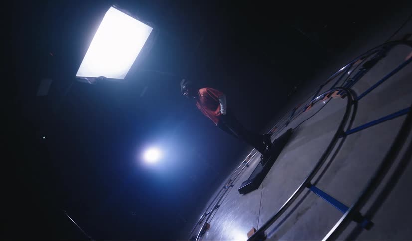 A man walking on a treadmill surrounded by filming equipment