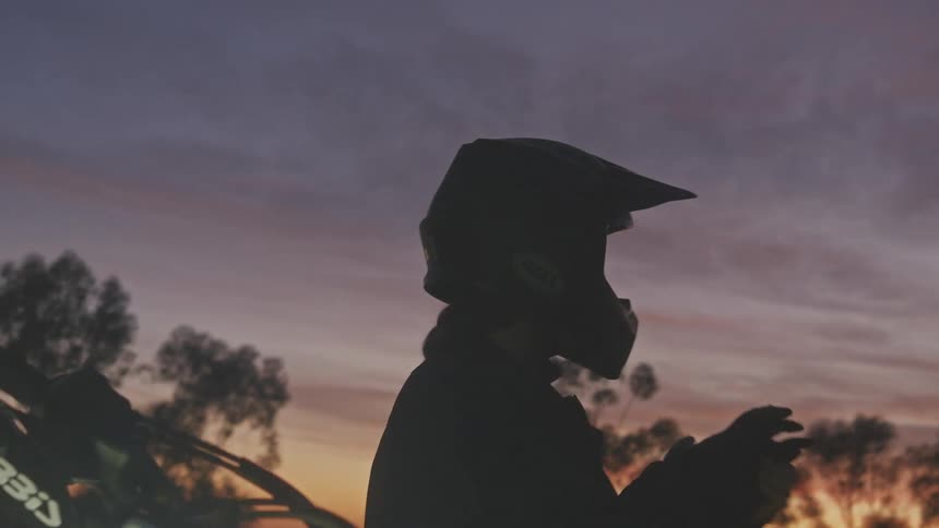 A man is wearing a helmet by the city