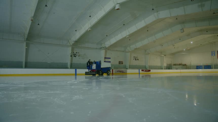 Zamboni resurfacing the ice in an indoor hockey rink