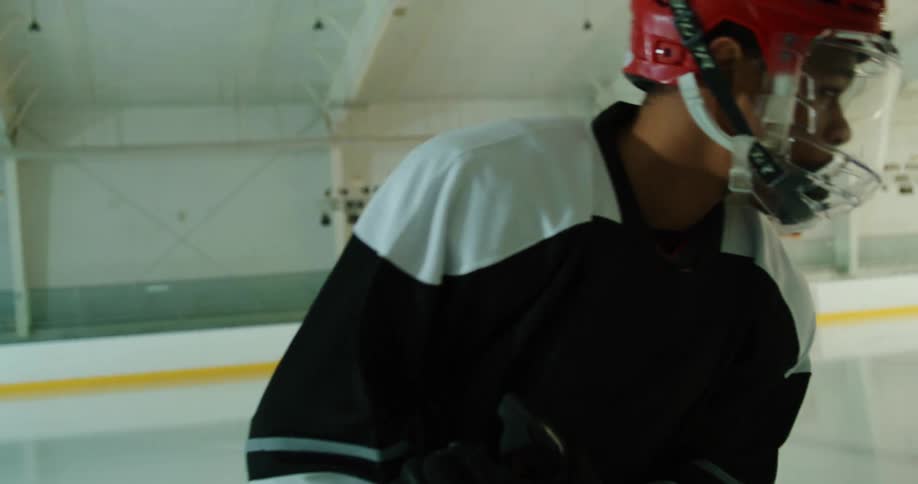 Black male hockey player skates on the ice