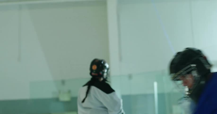 A girl shoots the puck at the net