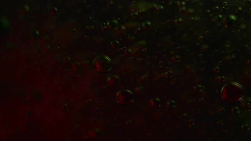 Colored bubbles float and fall in liquid