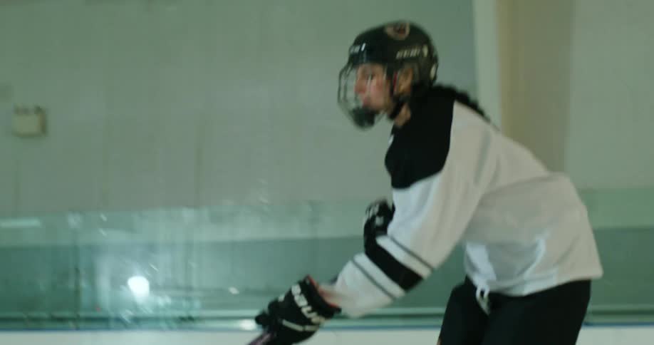 A woman scores a goal on the hockey rink