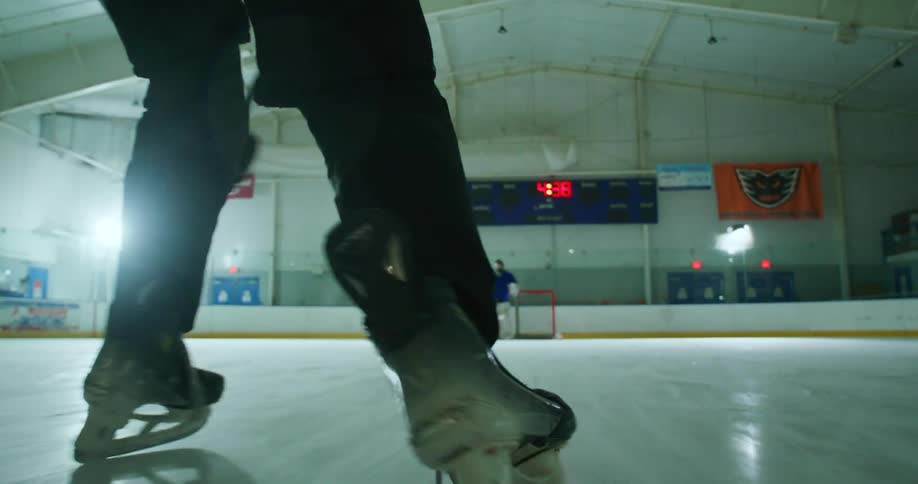 Person scoring a point with a puck on a hockey rink
