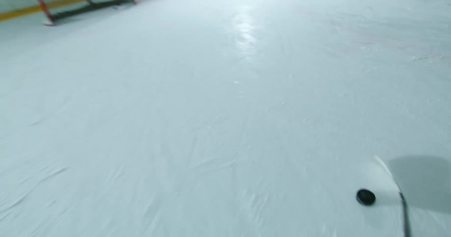 Point of view of a hockey player taking a shot with the puck