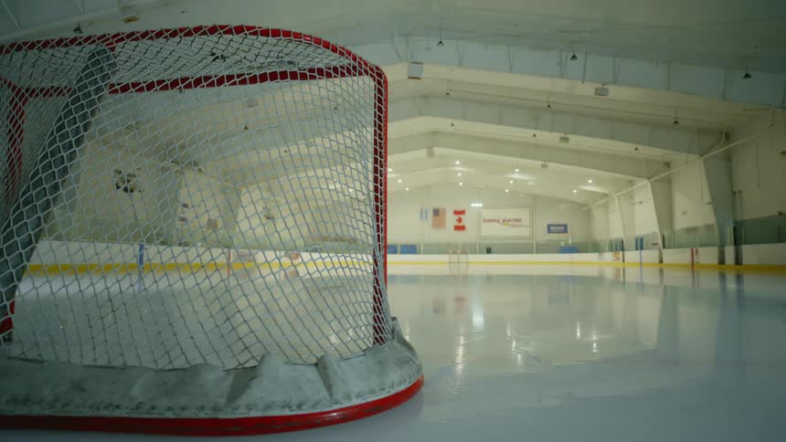 Lights on an empty ice hockey rink tunring on