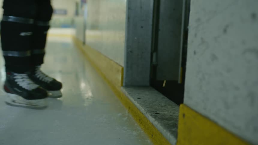 Hockey players step out of ice rink