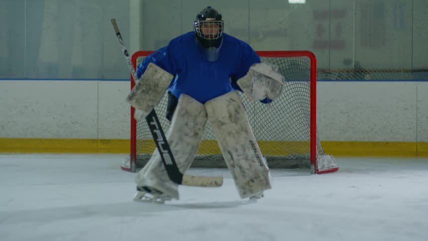 A goalie is ready at the net