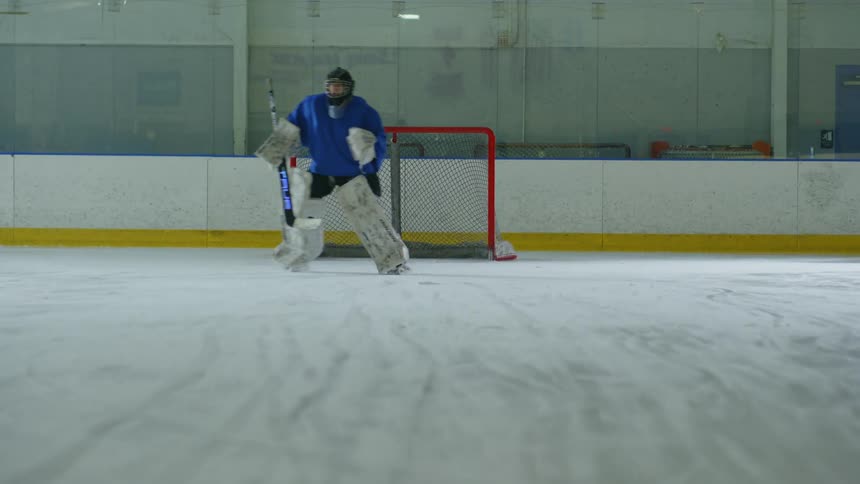 Player scoring a point on the goalkeeper in training on a hockey court