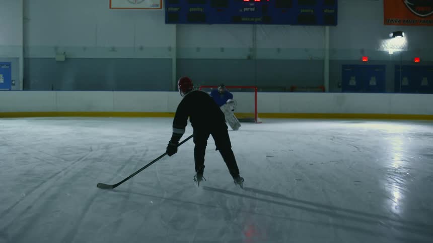 A player shoots the hockey puck at the net