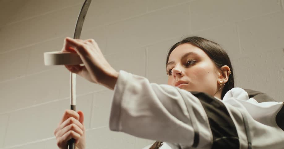 A hockey player wraps a stick with white tape