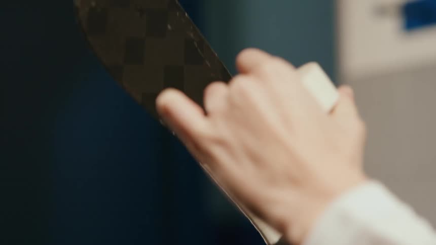White tape being placed on a hockey stick