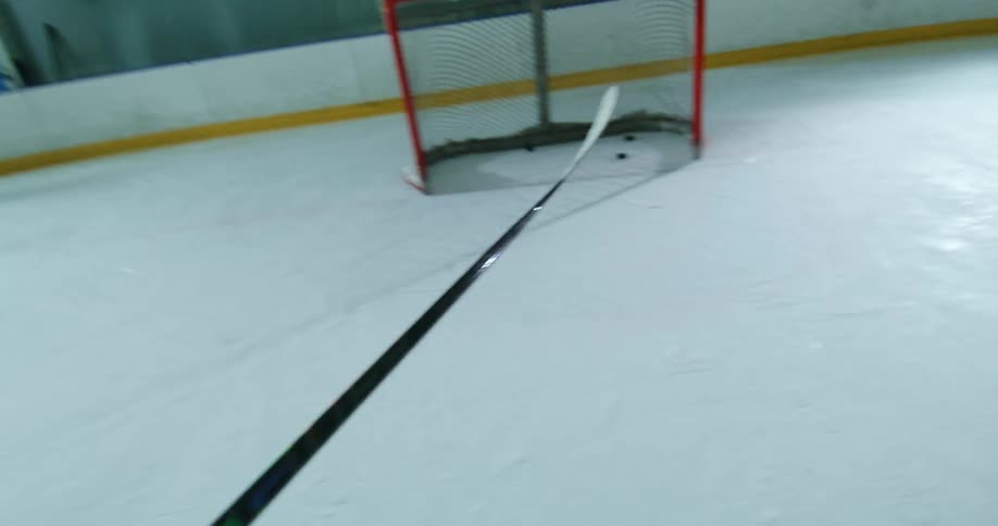 Juggling then shooting a hockey puck into an empty hockey goal